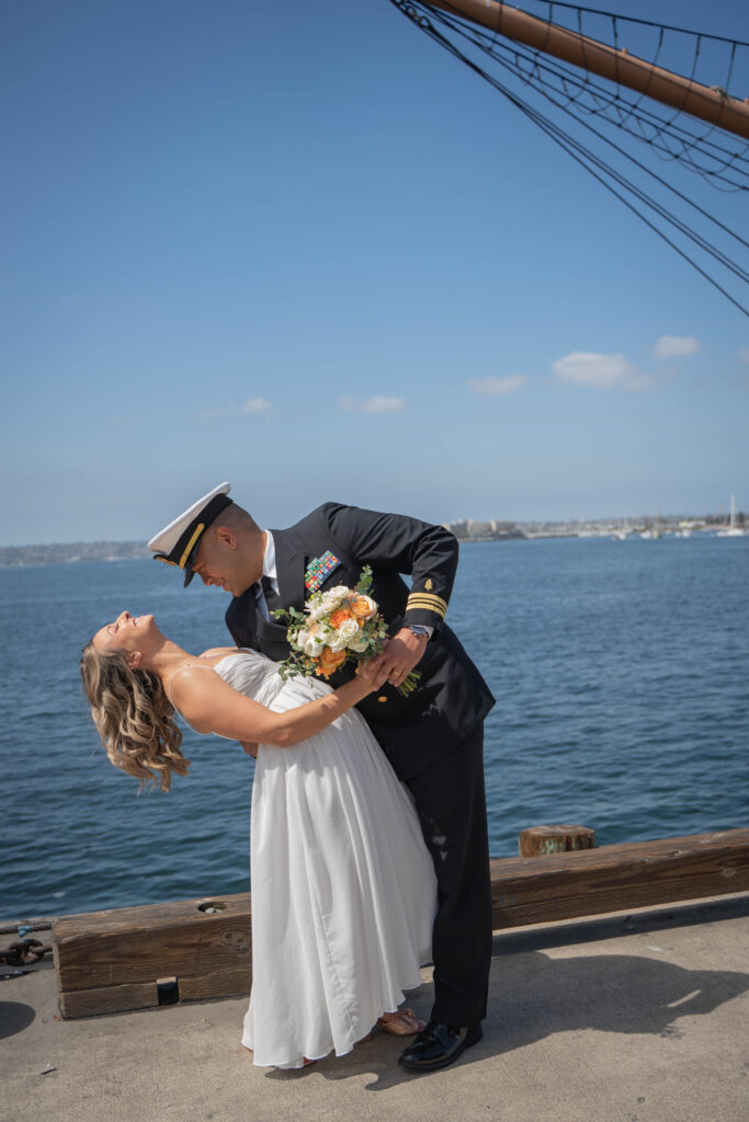 Couple doing "the dip" at San Diego harbor following their courthouse elopement.