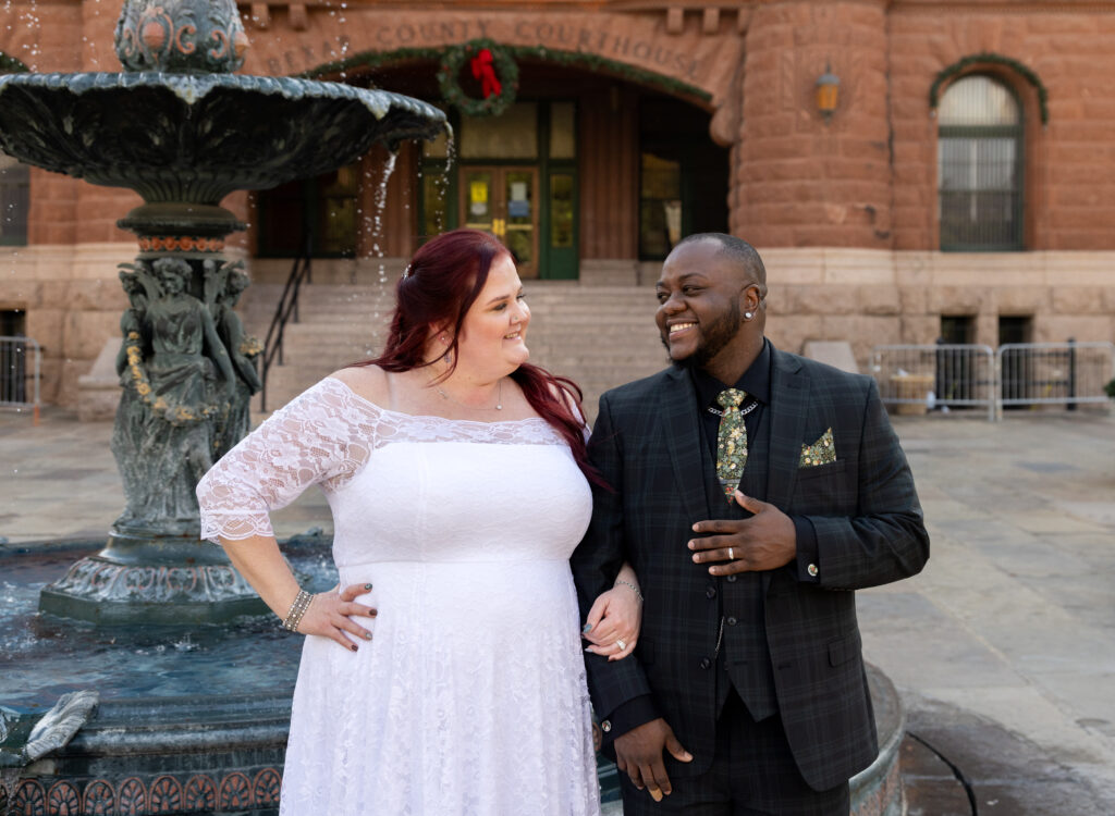 Couples looks lovingly at each other LGBTQ+ courthouse wedding