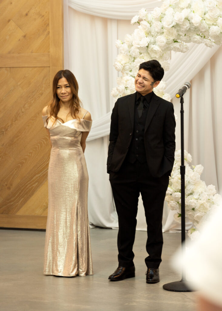 Groom beams looking at his bride walking down aisle at Carlsbad Windmill by Wedgewood Weddings