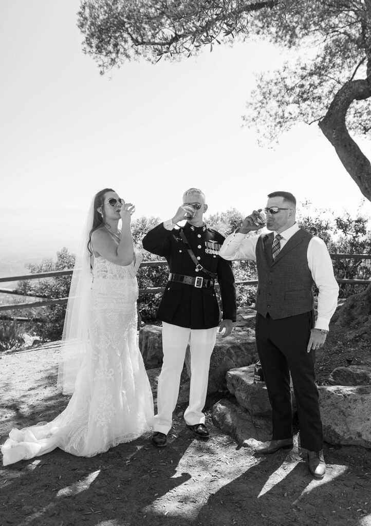 Couple + best man share celebratory whiskey shot at their elopement