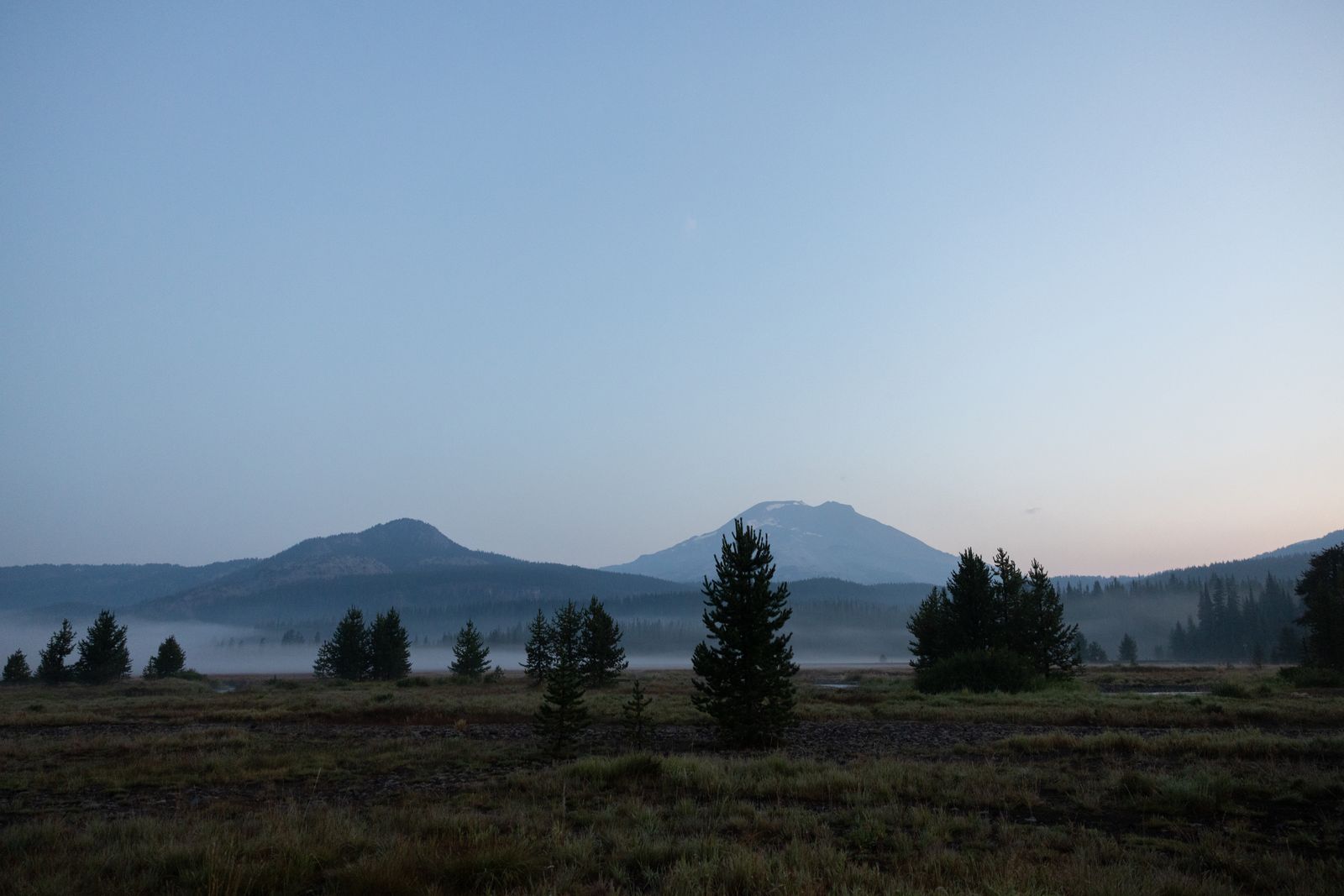 Sunrise over the meadows below South Sister and Broken Top at Sparks Lake in Central Oregon