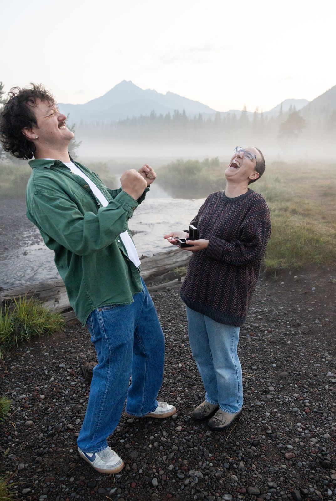 Laughing reaction to a surprise proposal with two rings at a Central Oregon engagement session