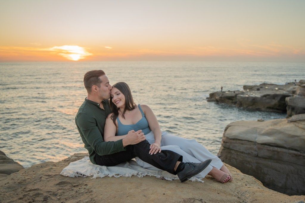 Couple sitting at Sunset Cliffs in San Diego